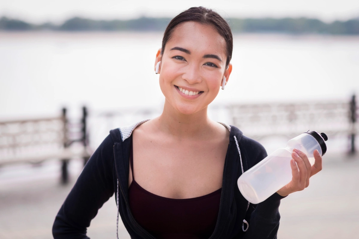 girl with drinking water after workout grass-fed protein