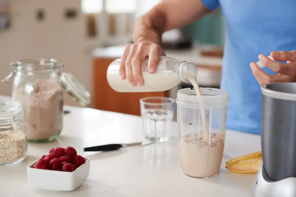 Person Making Protein Shake The Benefits of Grass-Fed Protein, New Zealand Whey Protein