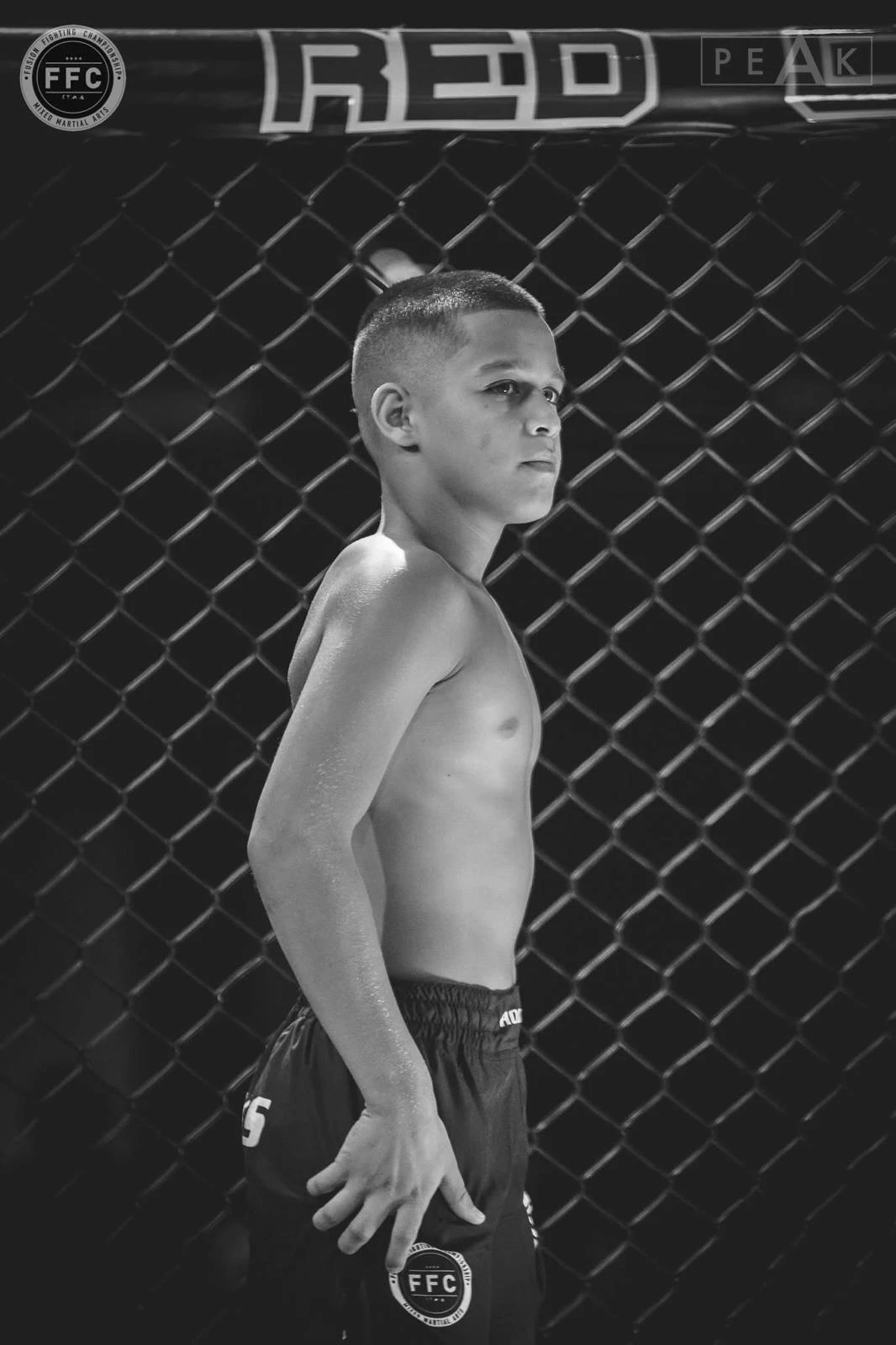 Mikail Tamoz standing confidently inside the MMA cage before competition